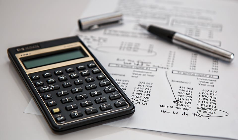 Resources 86 calculator pen and investment paperwork