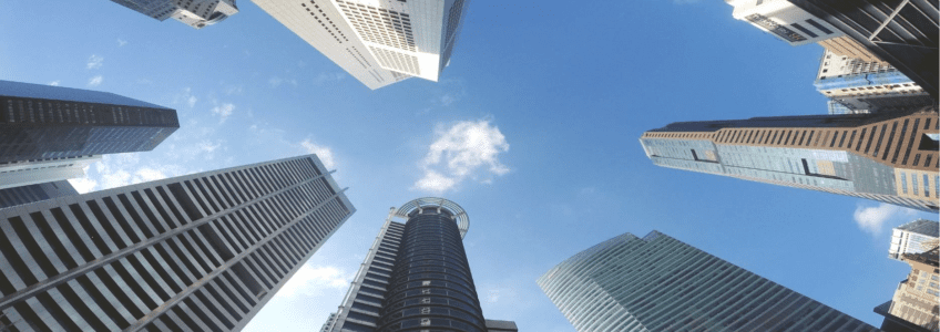 Driving the Acquisition Transition Phase: Role of M&A Support Services 50 oval view up of skyscraper buildings