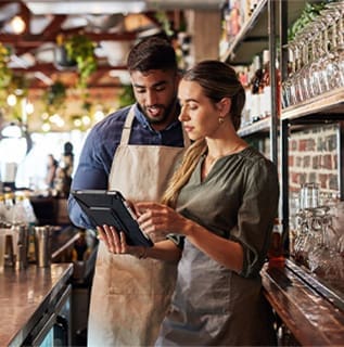 Hospitality (2) Man and woman review restaurant details on tablet
