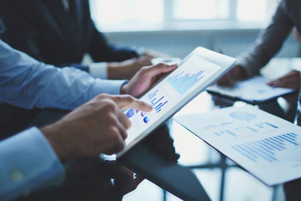 Utility Expense Management 6 businessperson pointing at document in touchpad at meeting